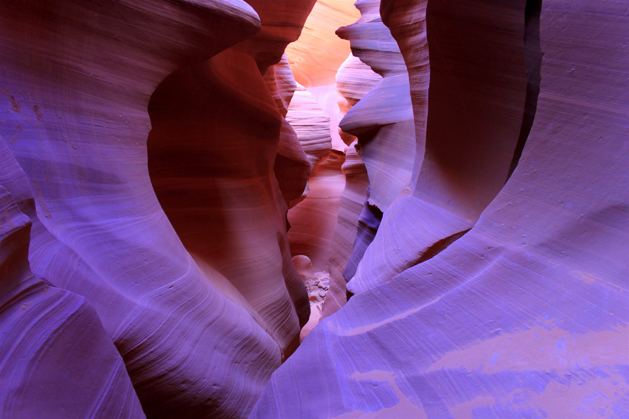 Light beams and sculpted sandstone walls inside a slot canyon near Page, Arizona