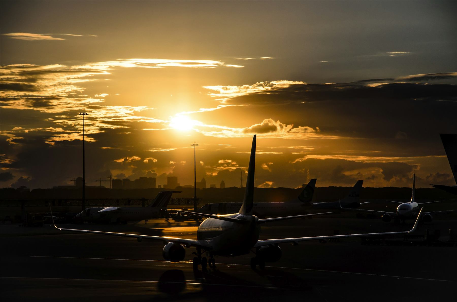 Aircraft on the tarmac at golden hour, representing arrival into Arizona