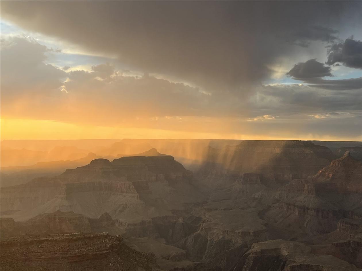 A desert rain storm over the Grand Canyon at sunset