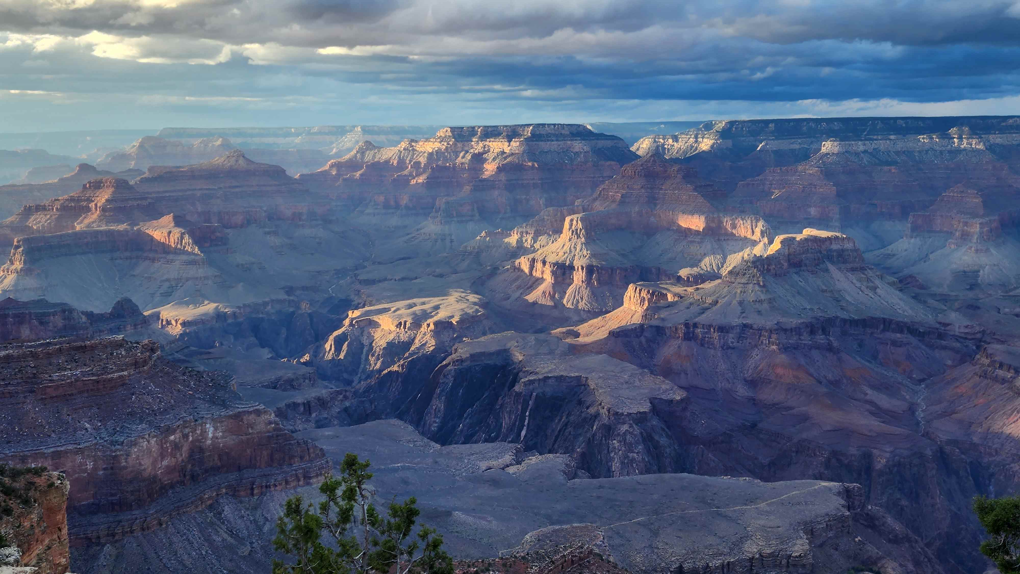 Patchy winter light and shadow across Grand Canyon rock layers