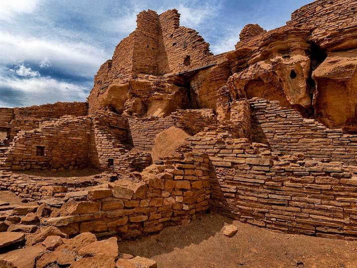 Wupatki Pueblo ruins of red sandstone under a dramatic sky