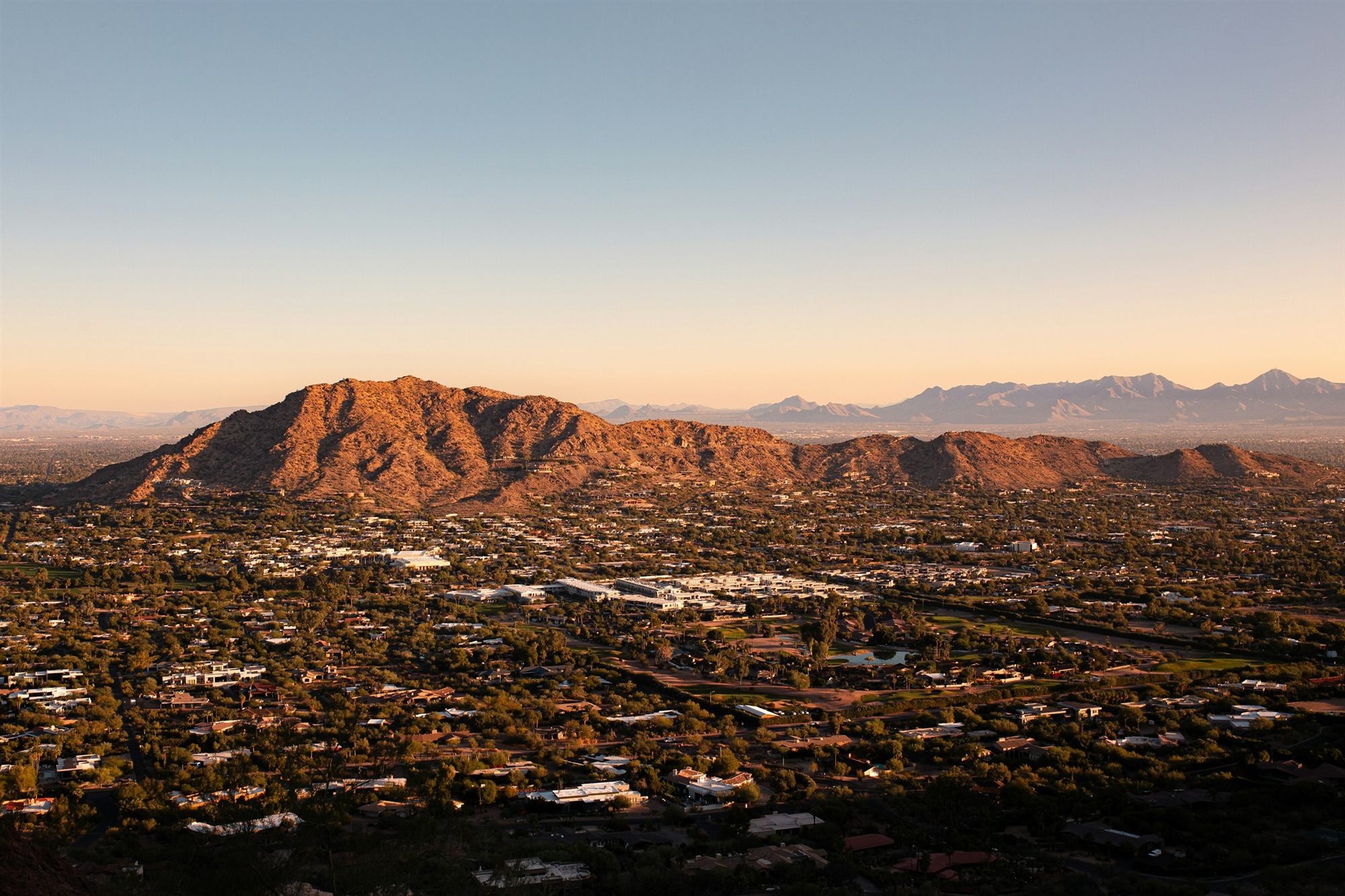 Golden-hour aerial view of desert mountains above a Scottsdale, Arizona resort community